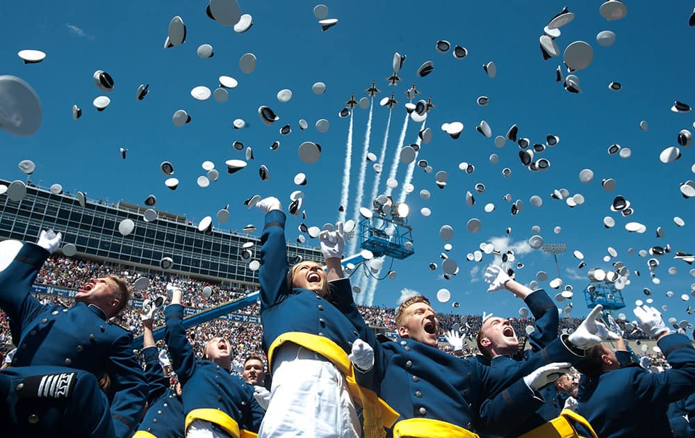 The Air Force Thunderbirds fly overhead as graduating cadets celebrate with the 