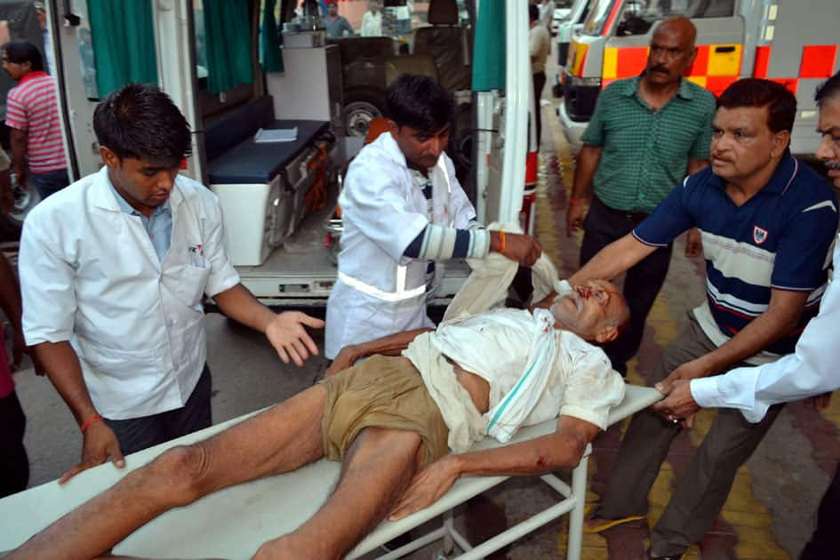 An encroacher being taken inside the District Hospital on a stretcher after he got injured during a clash, Mathura.