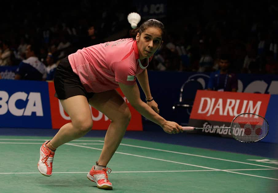 Saina Nehwal returns a shot to Spains Carolina Marin during their quaterfinal womens single match at the Indonesia Open badminton tournament at Istora Stadium in Jakarta.