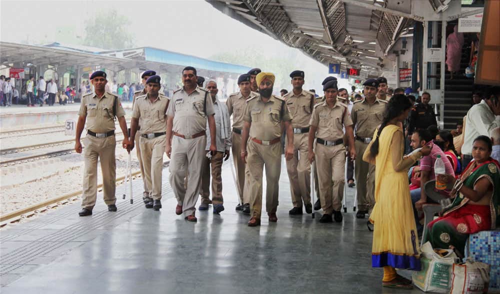 Police personnel patrol at the railway station in Gurgaon