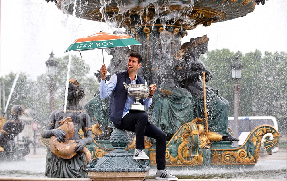 Novak Djokovic poses with the French Open tennis trophy during a photo session in Paris Novak Djokovic poses with the French Open tennis trophy during a photo session at the Place de la Concorde, in Paris.