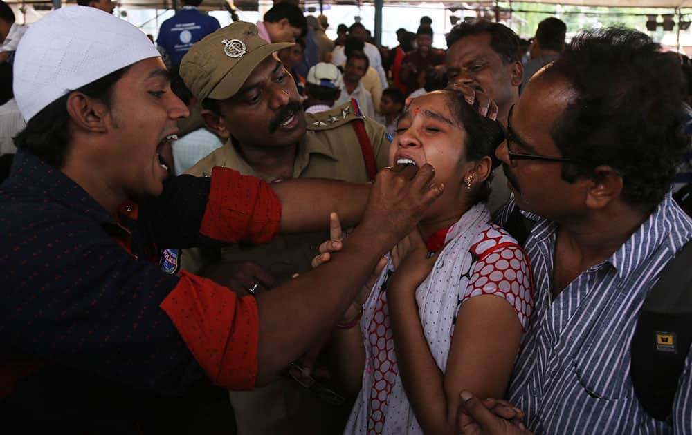 A volunteer administers fish medicine to an asthma patient in Hyderabad