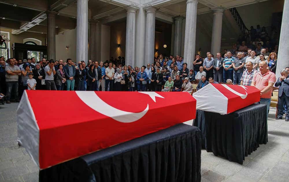 People attend a funeral ceremony at the Istanbul University