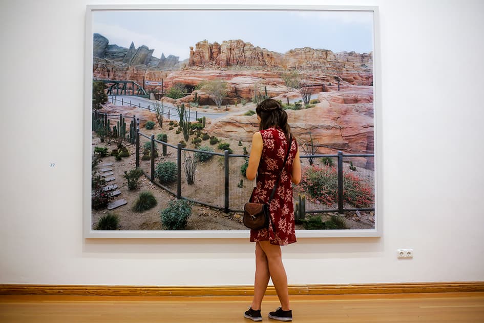 A woman inspects the art work