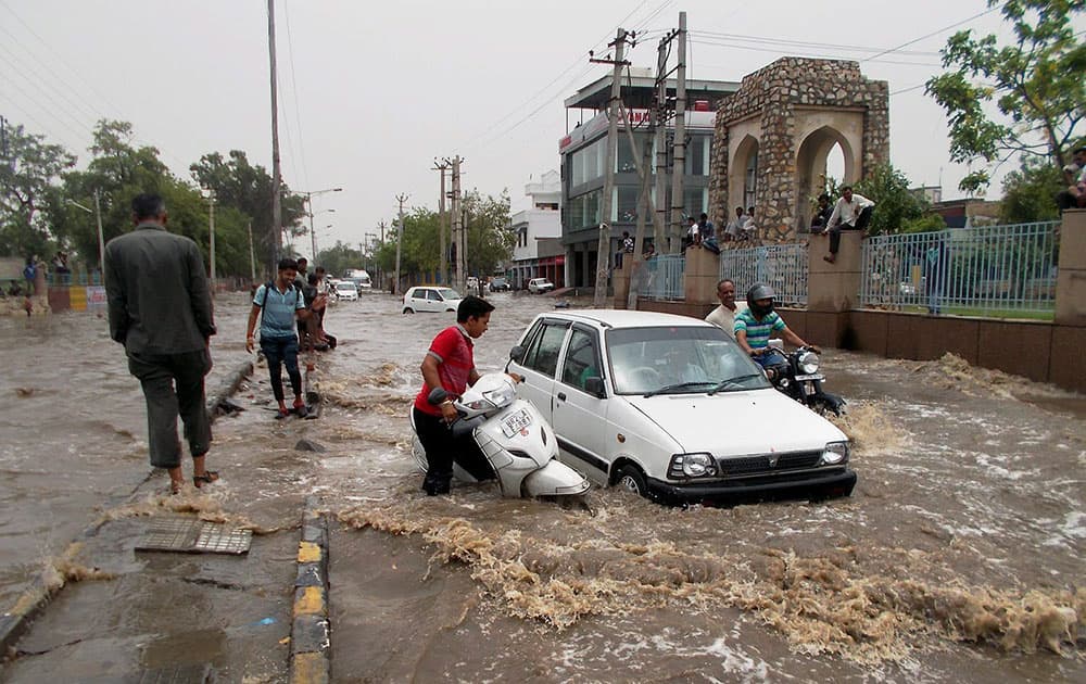 Vehicles stuck in a water logged street of Hissar following heavy rainfall.