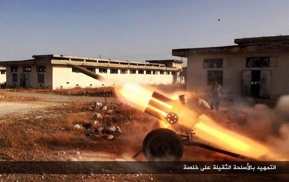 Nusra Front fighters firing multiple launcher rockets
