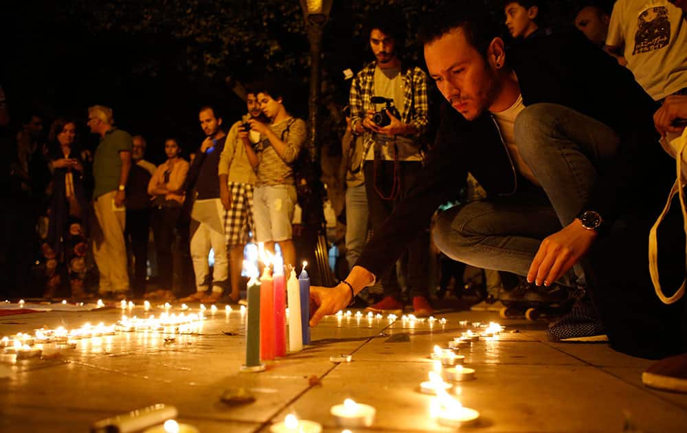A men lights his candles during a candlelight vigil in Morocco, for the victims of the Orlando nightclub shootings.