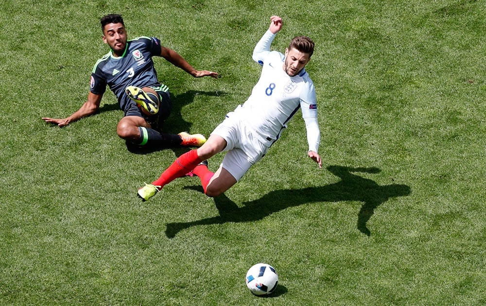 England's Adam Lallana, right, is tackled by Wales' Neil Taylor during the Euro 2016