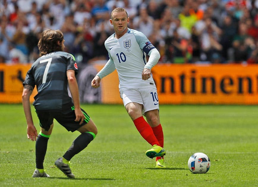 England's Wayne Rooney, right, passes the ball as Wales' Joe Allen looks at him, during the Euro 2016