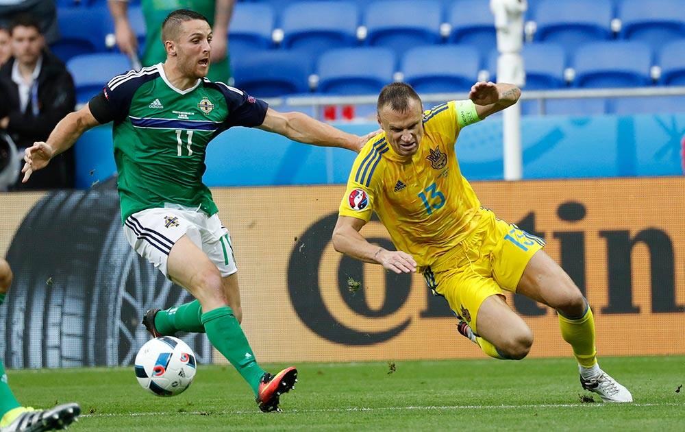 Ukraine's Vyacheslav Shevchuk, is challenged by Northern Ireland's Conor Washington