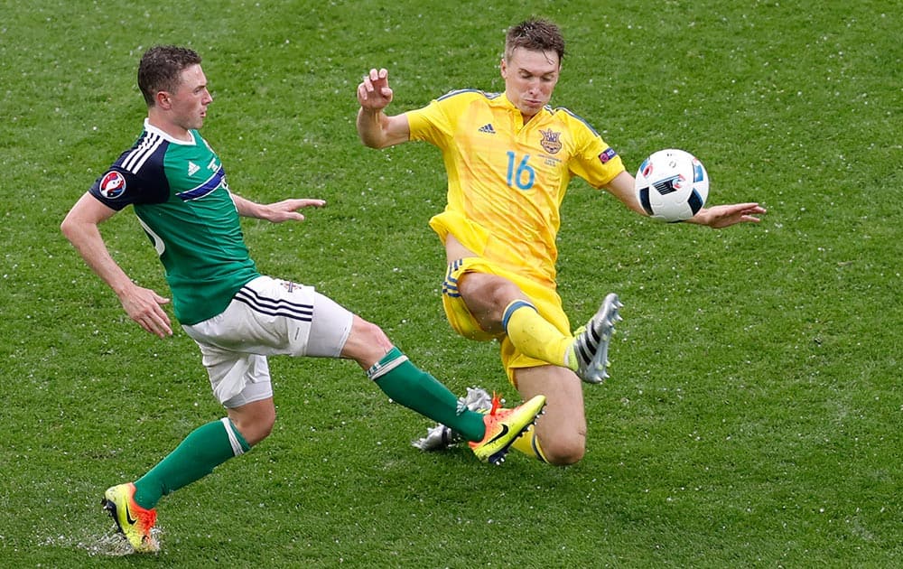 Northern Ireland's Kyle Lafferty, is tackled by Ukraine's Sergey Sydorchuk during the Euro 2016