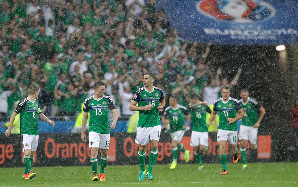 Northern Ireland players return to the center of the pitch after scoring the opening goal during the Euro 2016