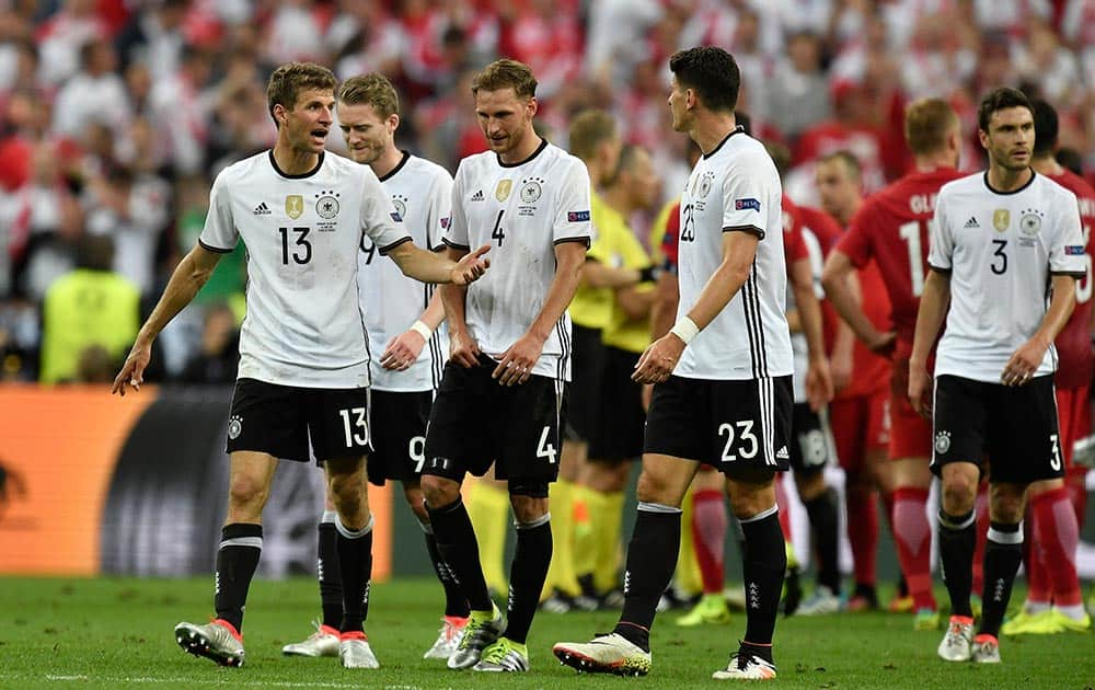 Germany's Thomas Mueller, talks to his teammates as they leave the pitch at the end of the Euro 2016