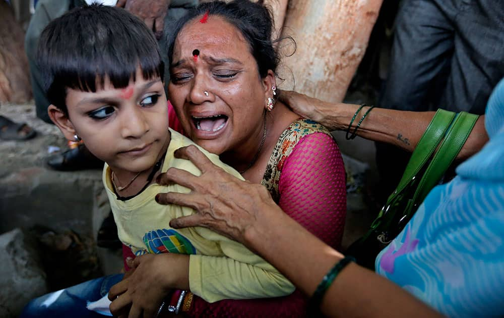 A relative of a man convicted for the 2002 Gujarat riots cries