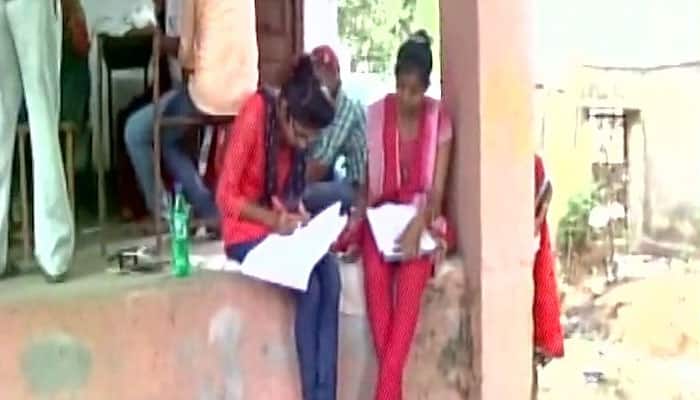 SHOCKING! Students in Bihar forced to sit on floor, use mobile lights to give exams