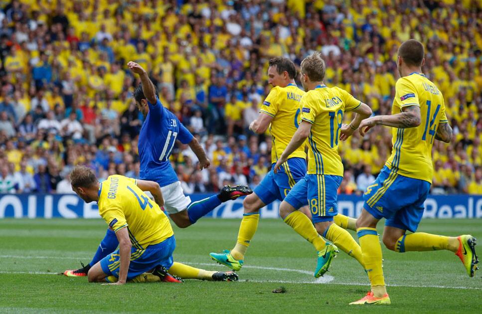 Italy's Eder, 2nd left, scores the opening goal