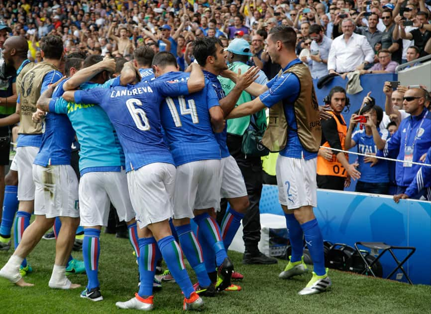 Italy players celebrate after Eder, center, scored the opening goal