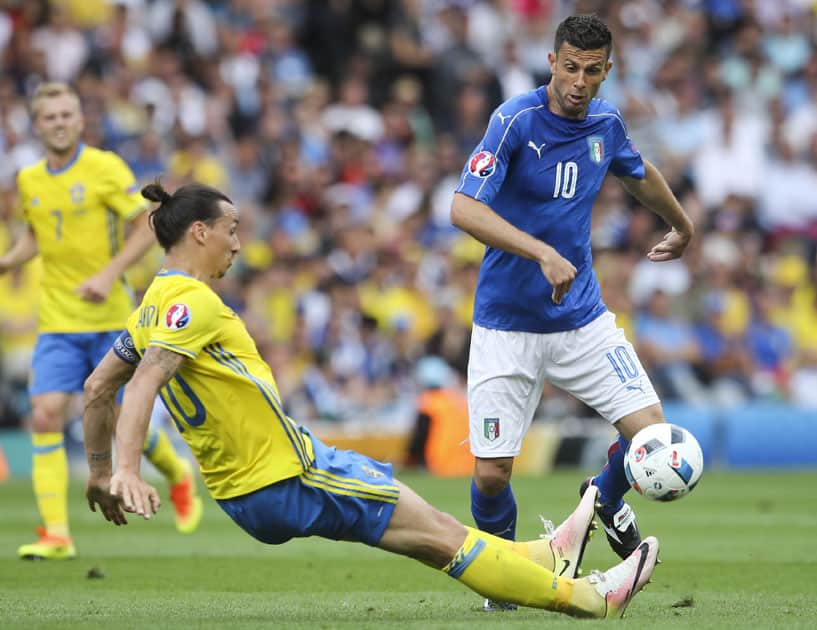 Italy's Thiago Motta, right, is tackled by Sweden's Zlatan Ibrahimovic