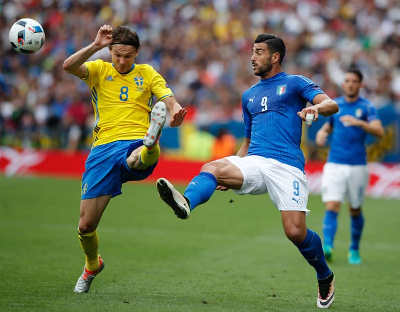 Italy's Graziano Pelle goes for the ball with Sweden's Albin Ekdal