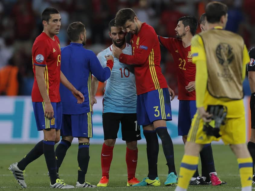 Gerard Pique hugs his FC Barcelona teammate Turkey's Arda Turan