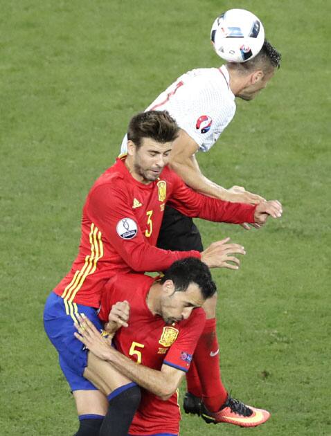 Turkey's Burak Yilmaz jumps for the ball