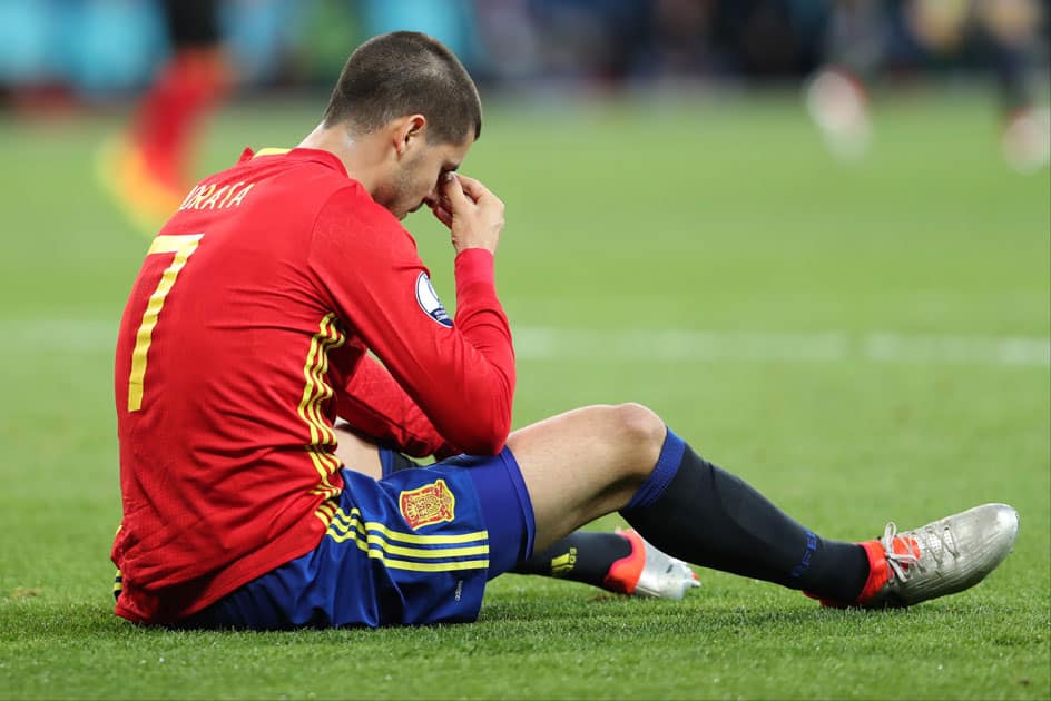 Alvaro Morata sits on the pitch during soccer match