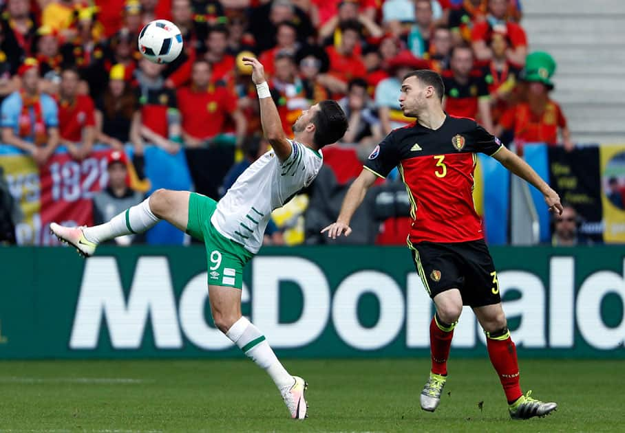 Belgium's Thomas Vermaelen, right, watches Ireland's Shane Long reach for the ball