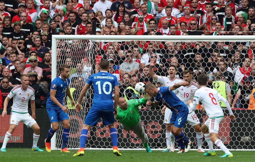 Hungary goalkeeper Gabor Kiraly, center left, reaches for the ball