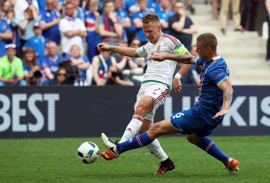 Hungary's Balazs Dzsudzsak, left, fights for the ball with Iceland's Ragnar Sigurdsson