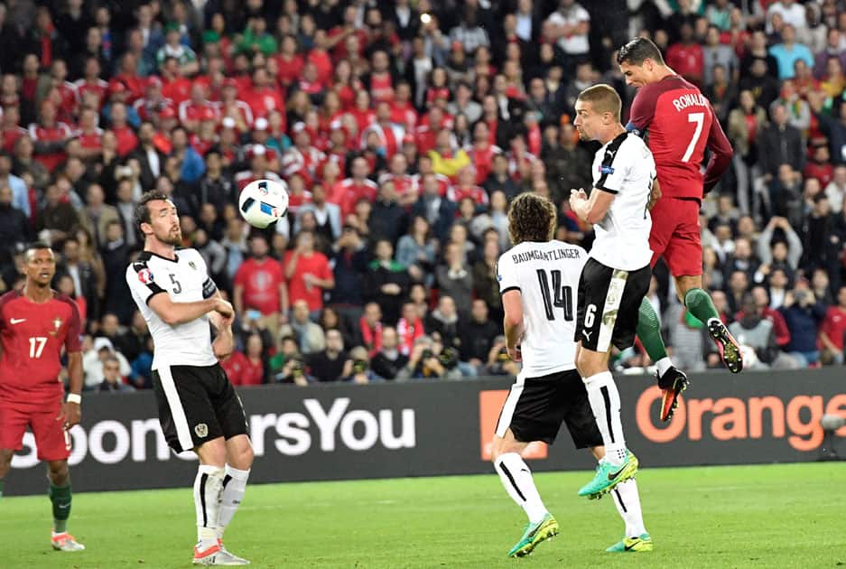 Cristiano Ronaldo, right, attempts a header at the goal