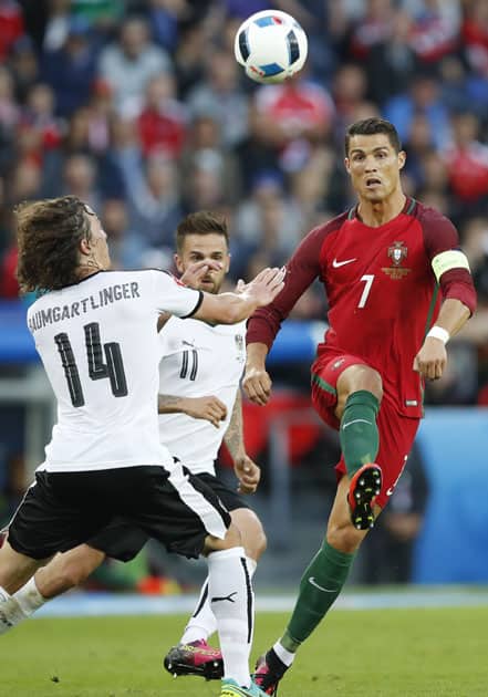 Cristiano Ronaldo, right, goes for the ball 