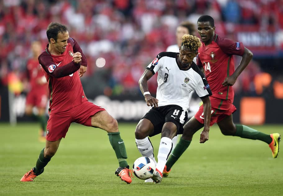 Ricardo Carvalho, left, fights for the ball