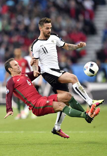 Ricardo Carvalho, left, fights for the ball