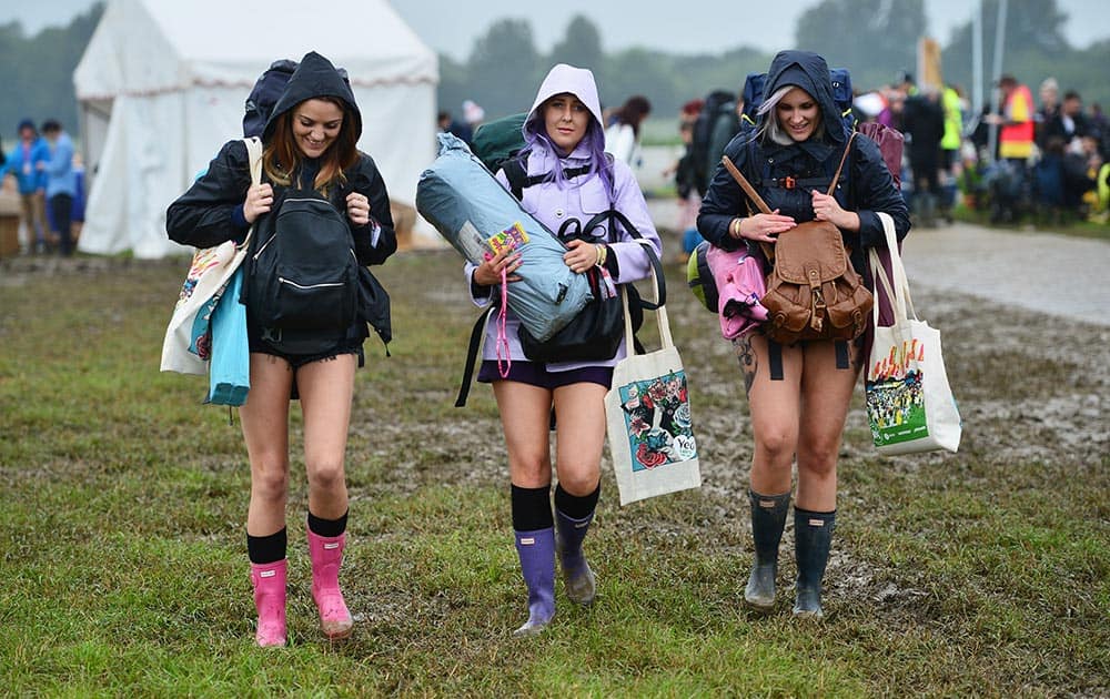 Festival goers arrive for the Glastonbury festival at Worthy Farm, in Somerset, England.