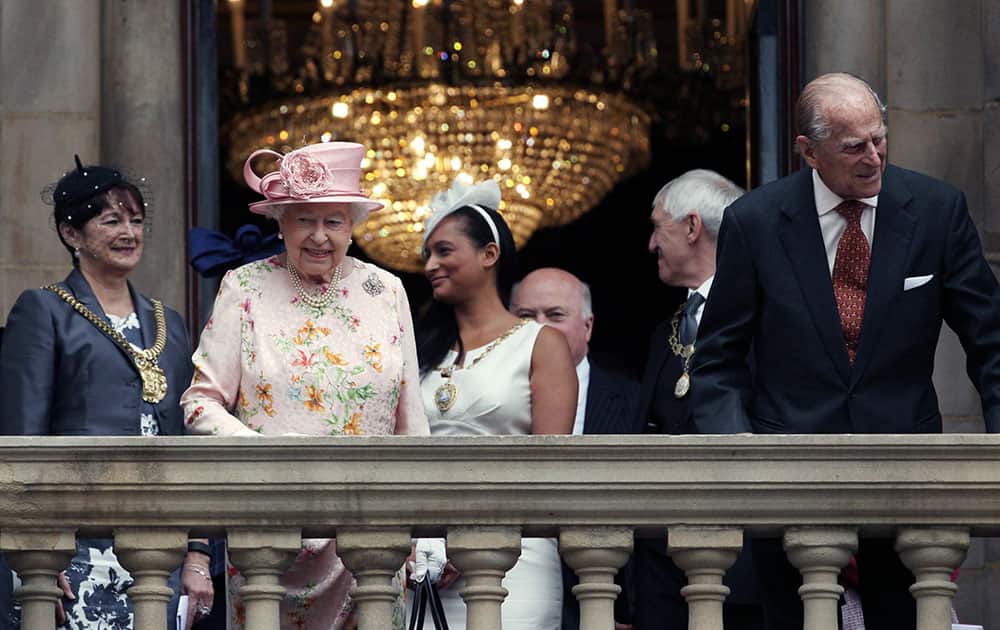 Britain's Queen Elizabeth and Prince Philip smile from the balcony at Liverpool