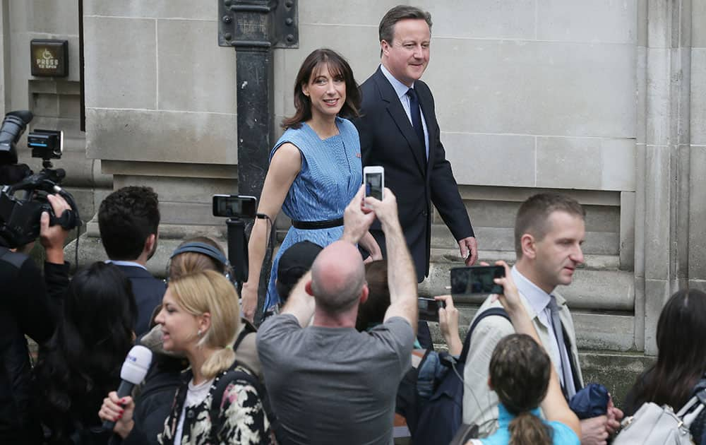 British Prime Minister David Cameron and his wife Samantha leave after casting their votes