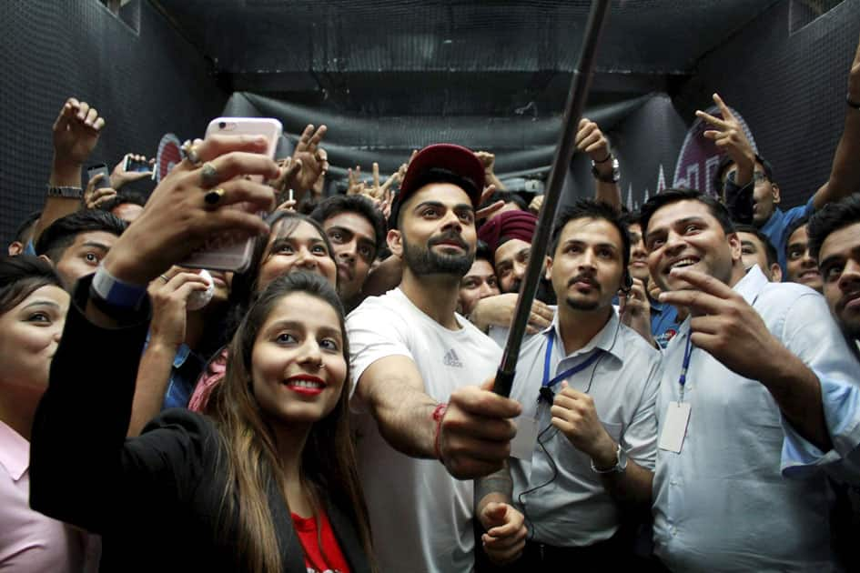 Cricketer Virat Kohli takes selfie with fans