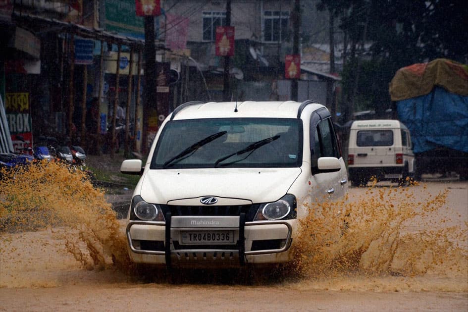 A Vehicle moves through a flooded road