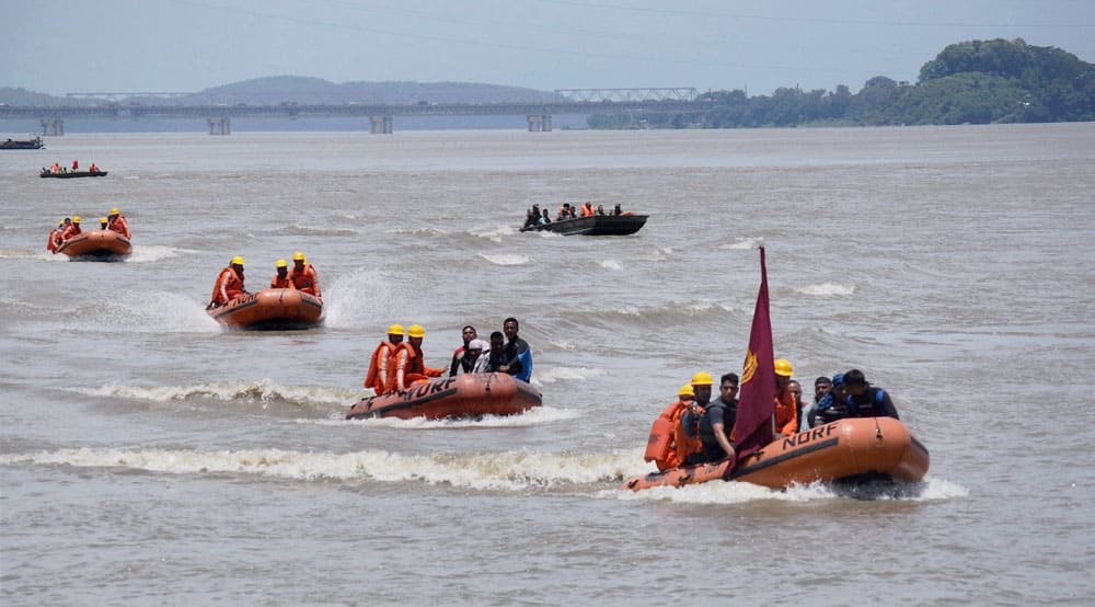 NDRF personnel during a mock drill “Jalrahat” on rescue of people affected by the floods, at Brahamaputra River in Guwahati.