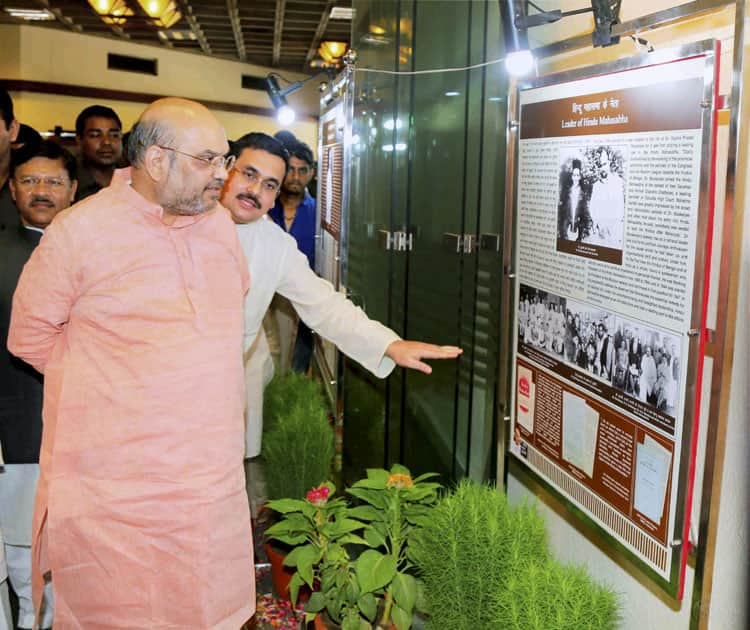 BJP President Amit Shah looking at photographs