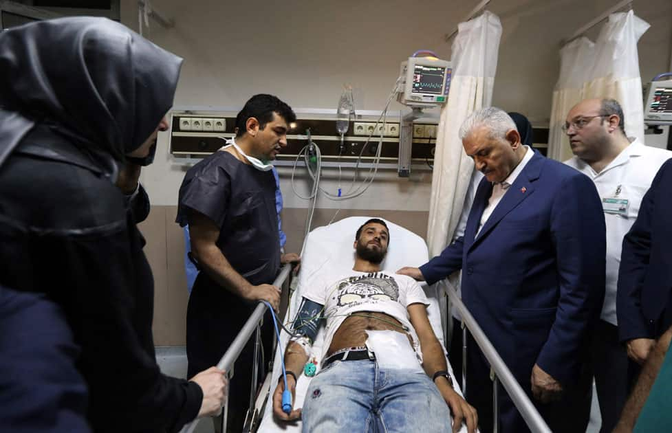 Turkish Prime Minister Binali Yildirim visit a wounded man at a hospital