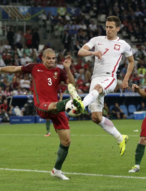  Pepe, left, tries to stop Poland's Arkadiusz Milik from taking a shot