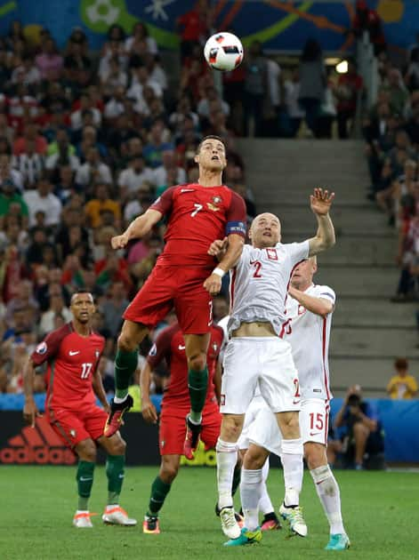 Cristiano Ronaldo, left, jumps for the ball