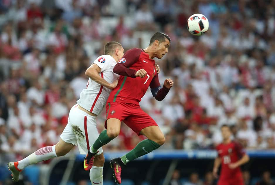  Cristiano Ronaldo, right, heads a ball next to Poland's Artur Jedrzejczyk