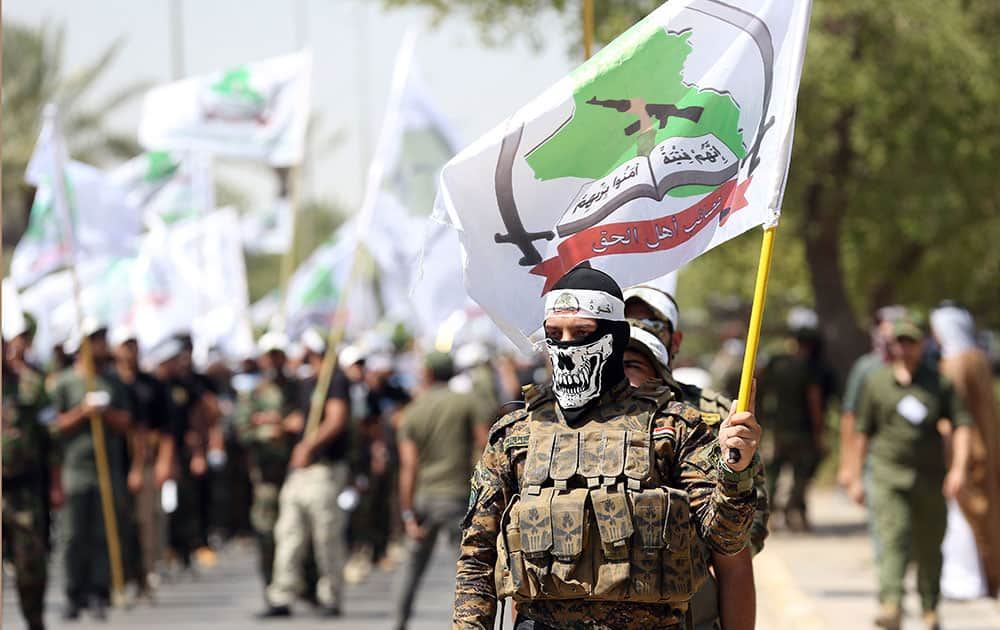 Members of Iraqi Popular Mobilization Forces parade