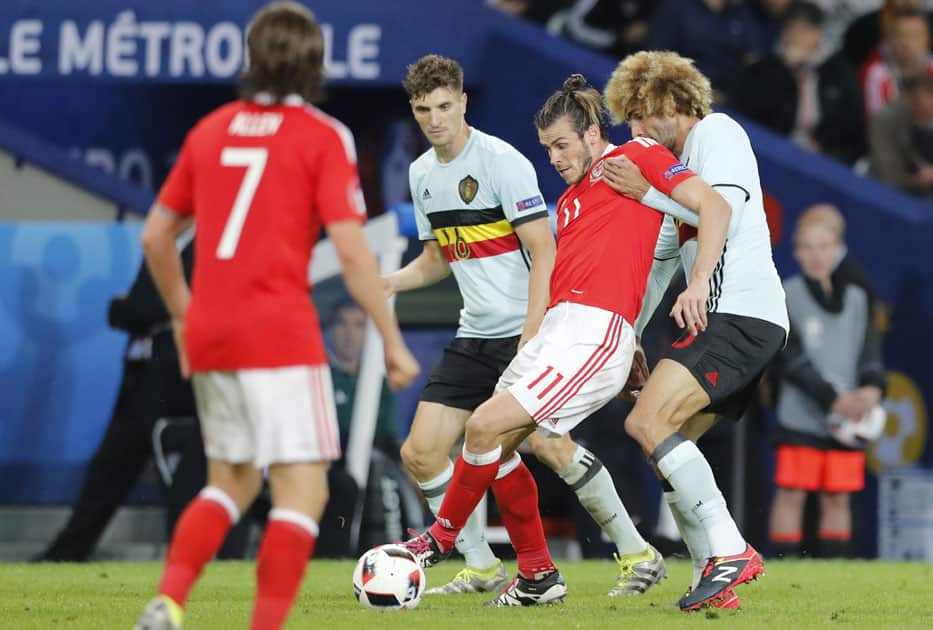 Wales' Gareth Bale is challenged by Belgium's Marouane Fellaini, right