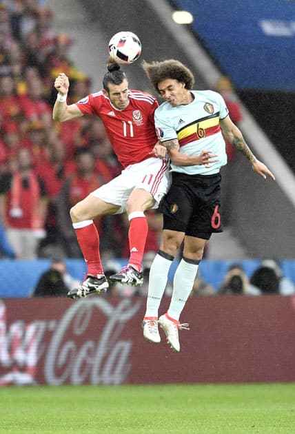 Gareth Bale, left, jumps for the ball with Belgium's Axel Witsel