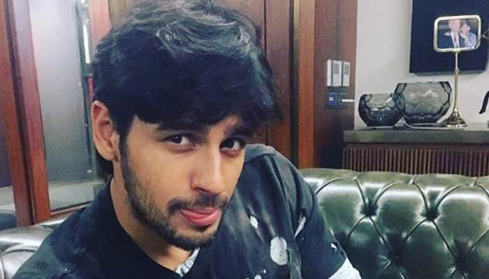 Oh so cute! Sidharth Malhotra poses with newest member of Johar family- See pic