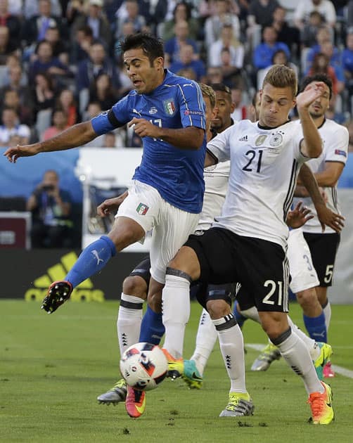 Italy's Eder, left, and Germany's Joshua Kimmich challenge for the ball