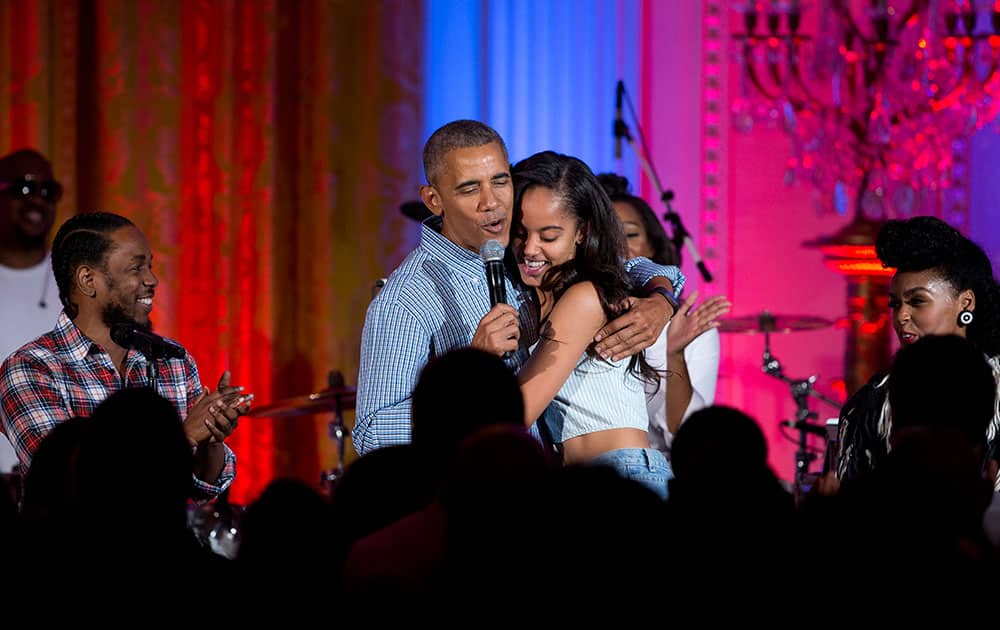 President Barack Obama hugs and sings 